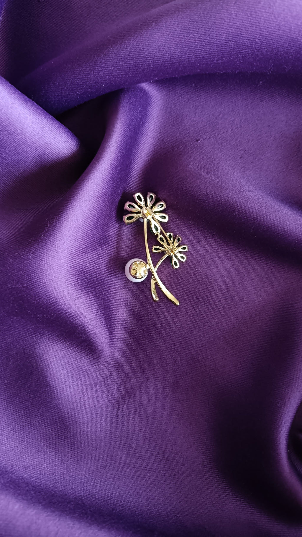 Gold Emerald Crystal Daisy Double Bloom & Pearl Lapel Brooch Pin reverse side flat lay on purple fabric showing gold twig stem and pin back closure