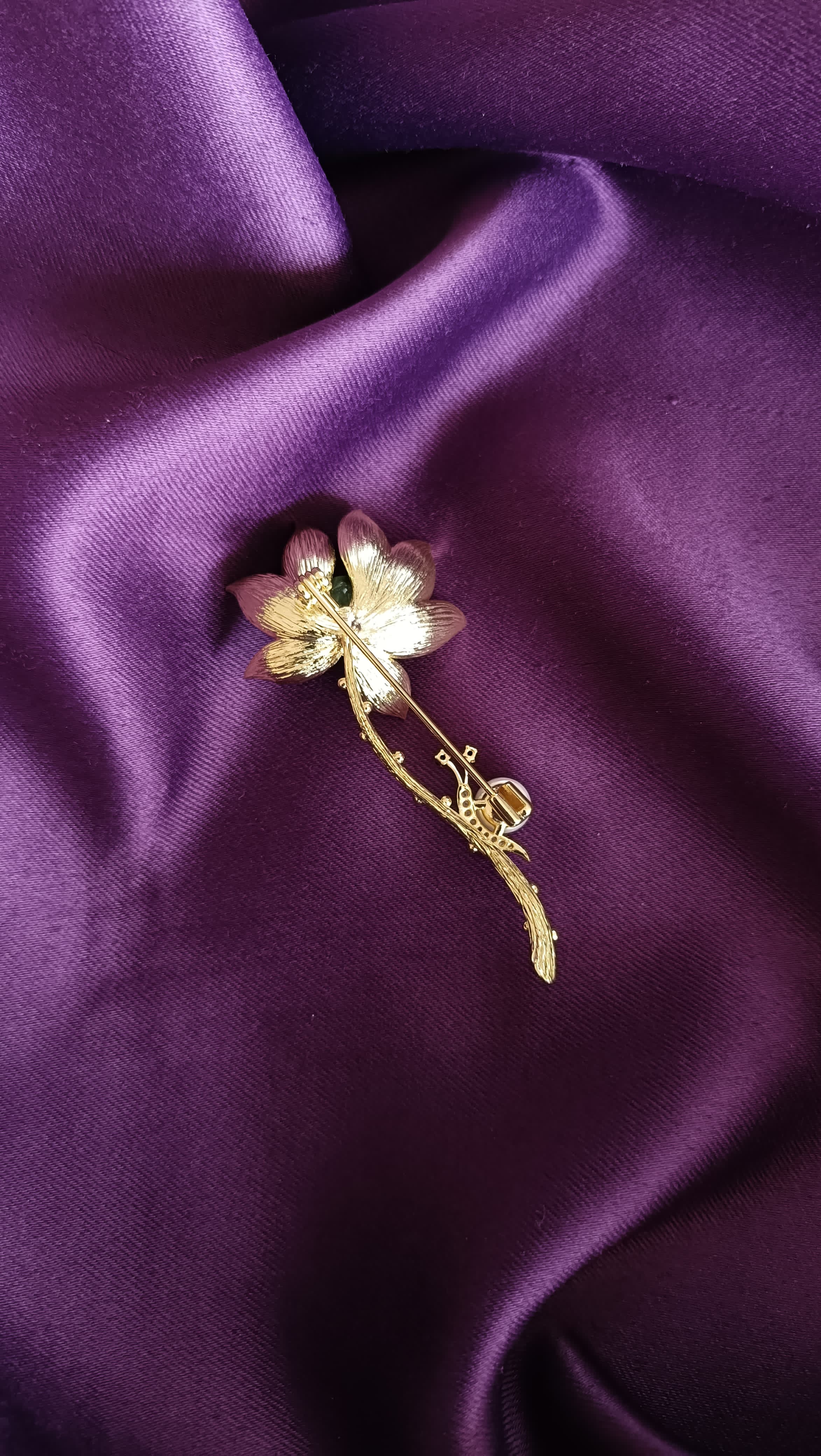 Gold Deep Blue Enamel Lotus Bloom Long Stem Lapel Brooch Pin reverse side flat lay on purple fabric showing gold botanical twig stem detail and pin back closure