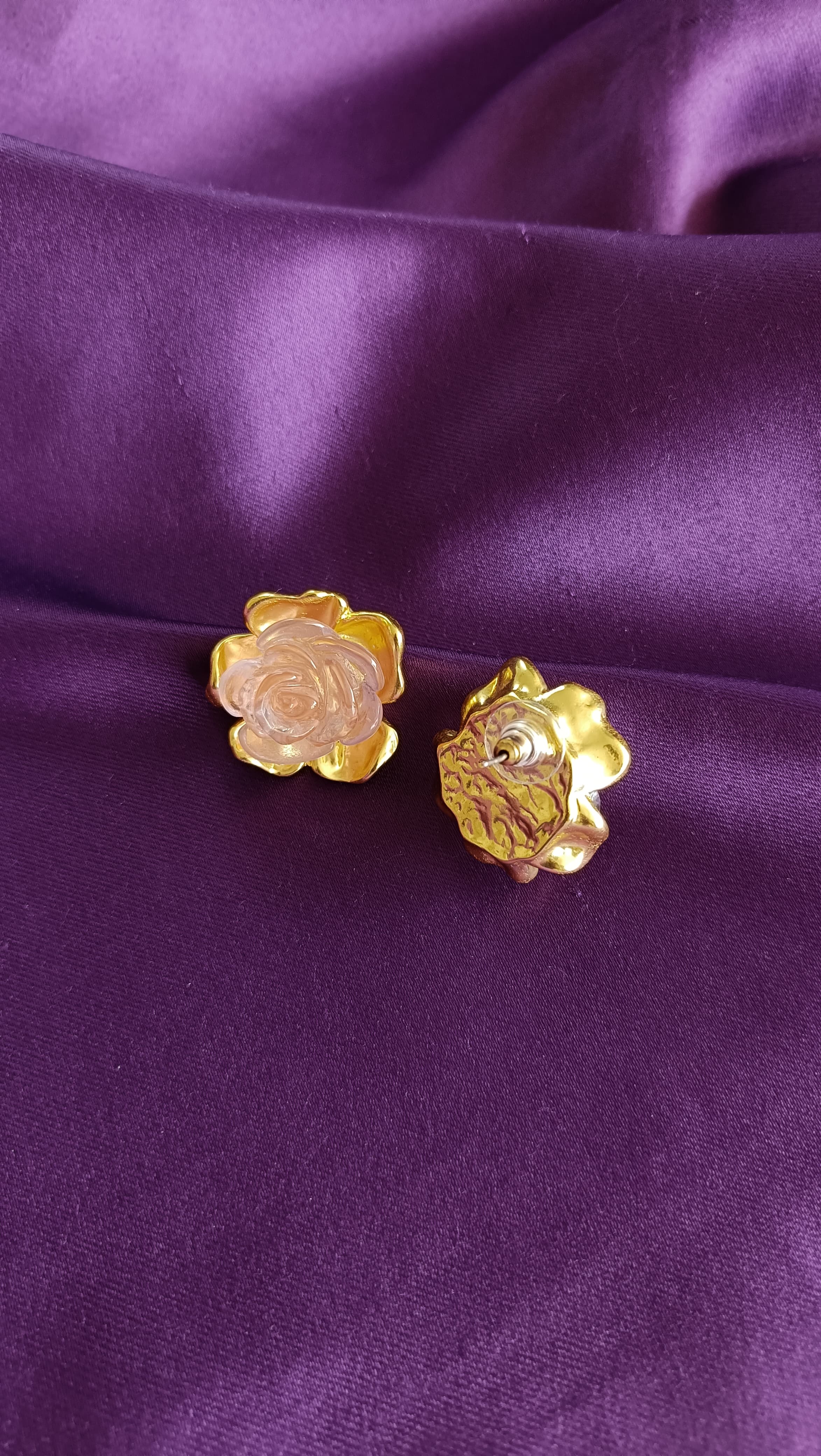 Gold Rose Quartz Carved Rose Stud Earrings flat lay showing front and back on purple fabric