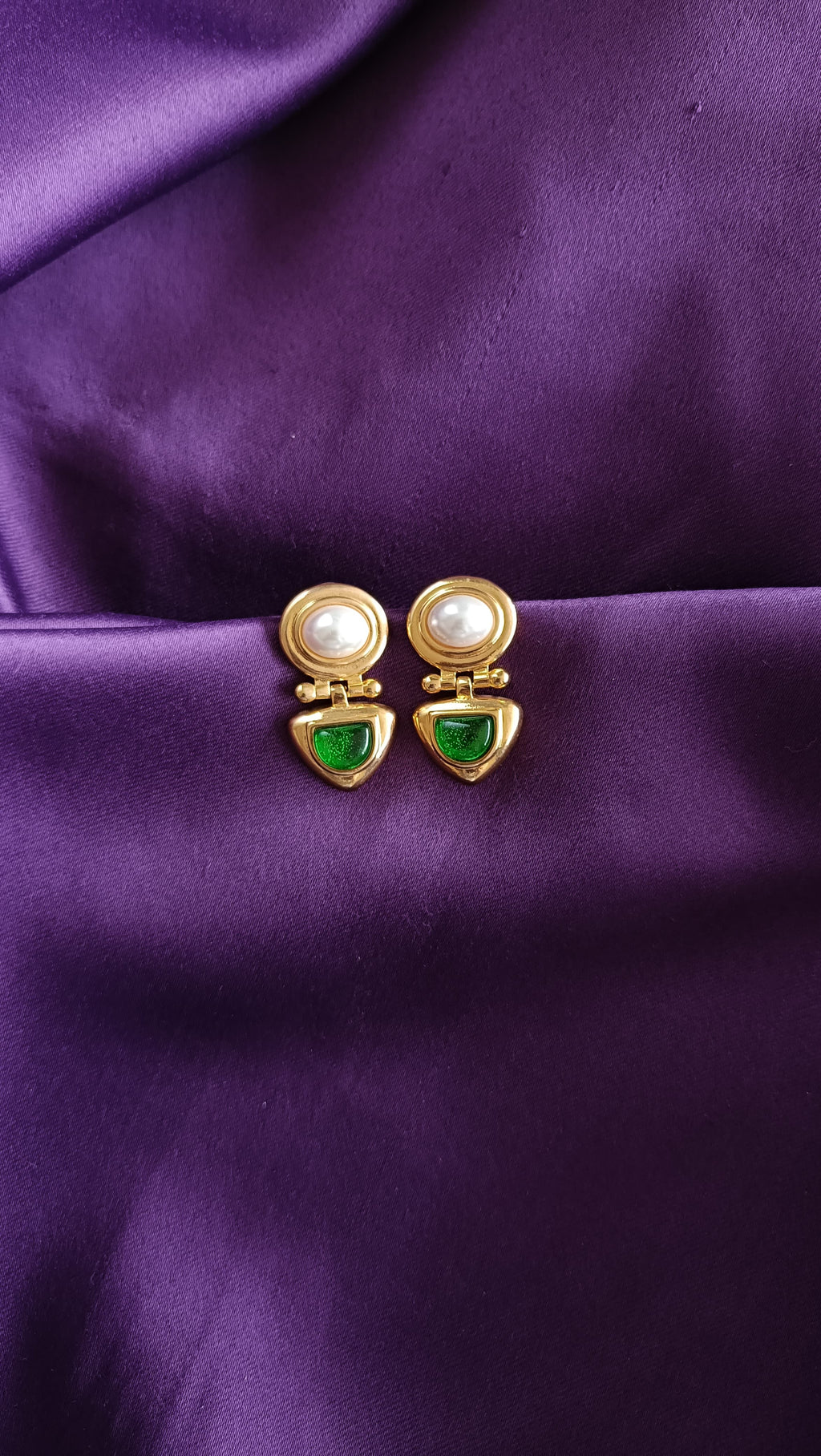 Gold Pearl & Emerald Green Cabochon Hinged Drop Earrings pair flat lay on purple fabric
