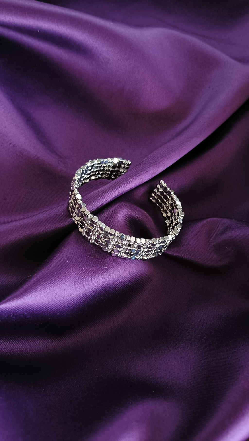 Silver Multi-Strand Sequin Disc Cuff Bracelet open cuff flat lay on purple fabric