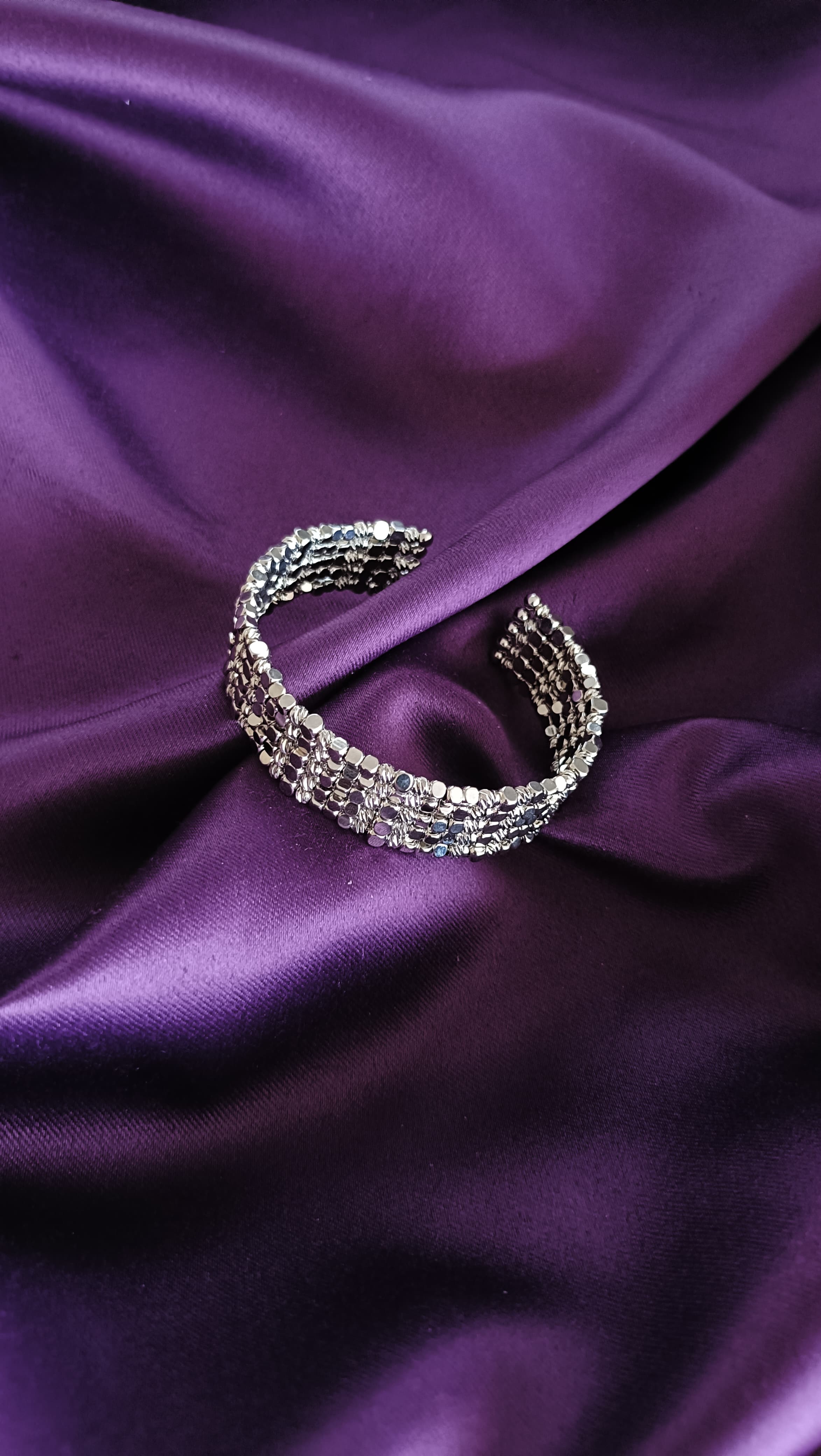 Silver Multi-Strand Sequin Disc Cuff Bracelet open cuff flat lay on purple fabric