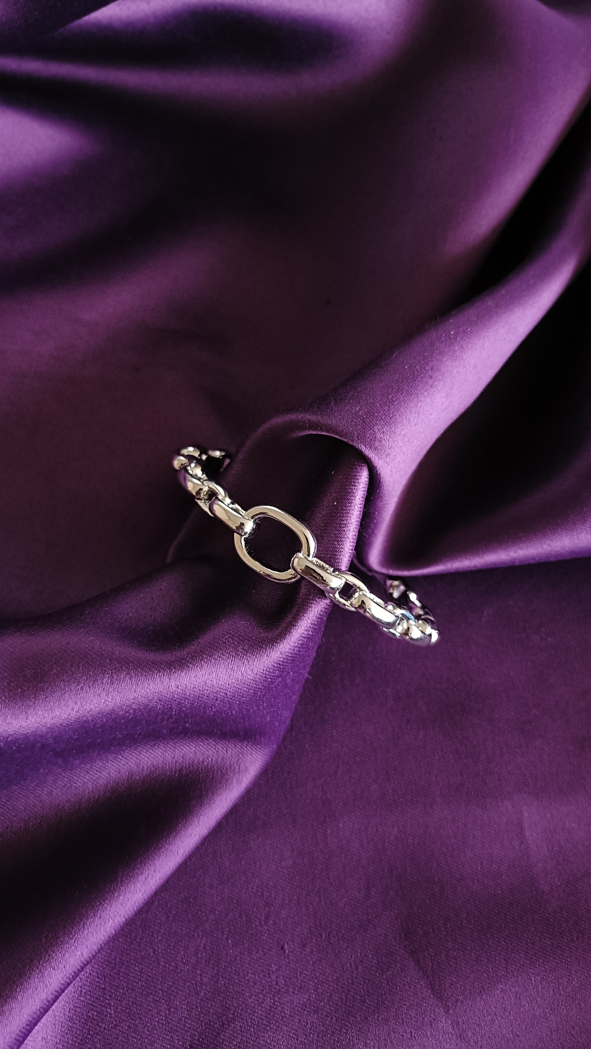 Silver Chunky Oval Link Chain Cuff Bracelet with O-Ring close-up flat lay on purple fabric