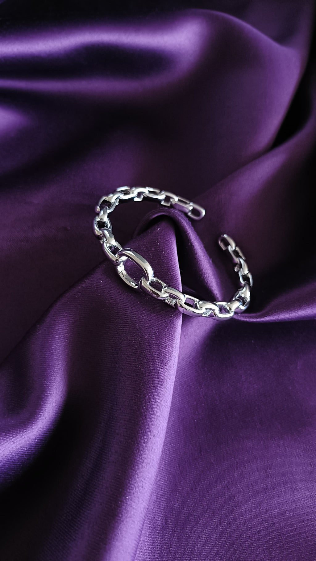 Silver Chunky Oval Link Chain Cuff Bracelet with O-Ring full view flat lay on purple fabric