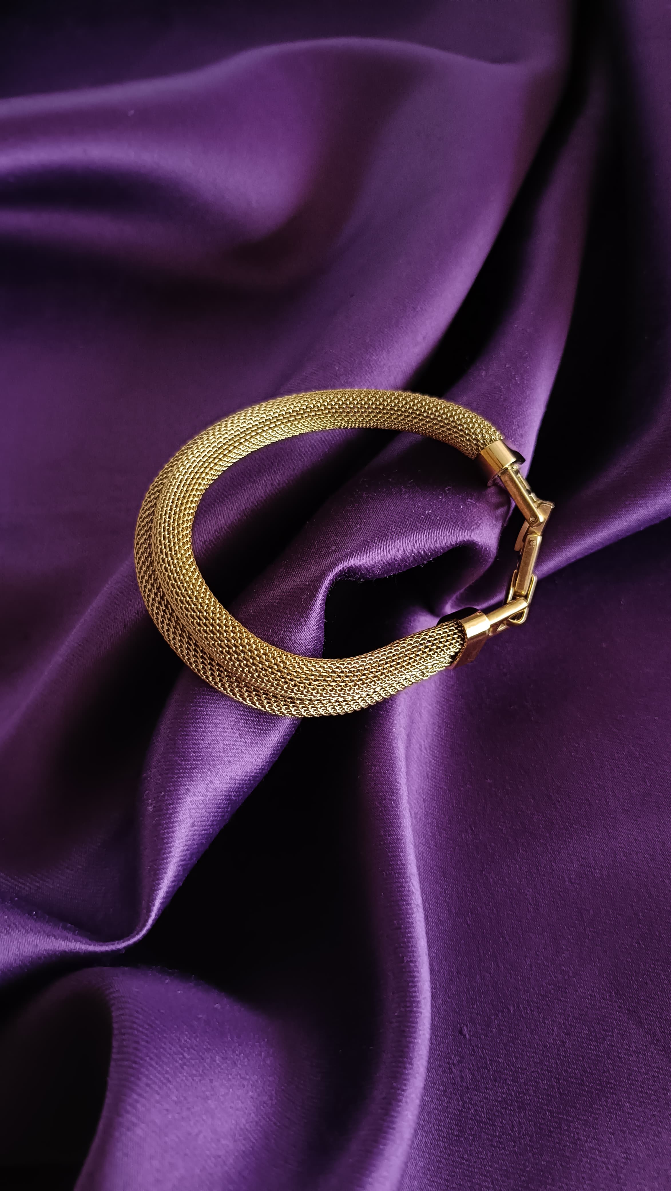 Gold Wide Mesh Tube Bangle Bracelet full view flat lay on purple fabric