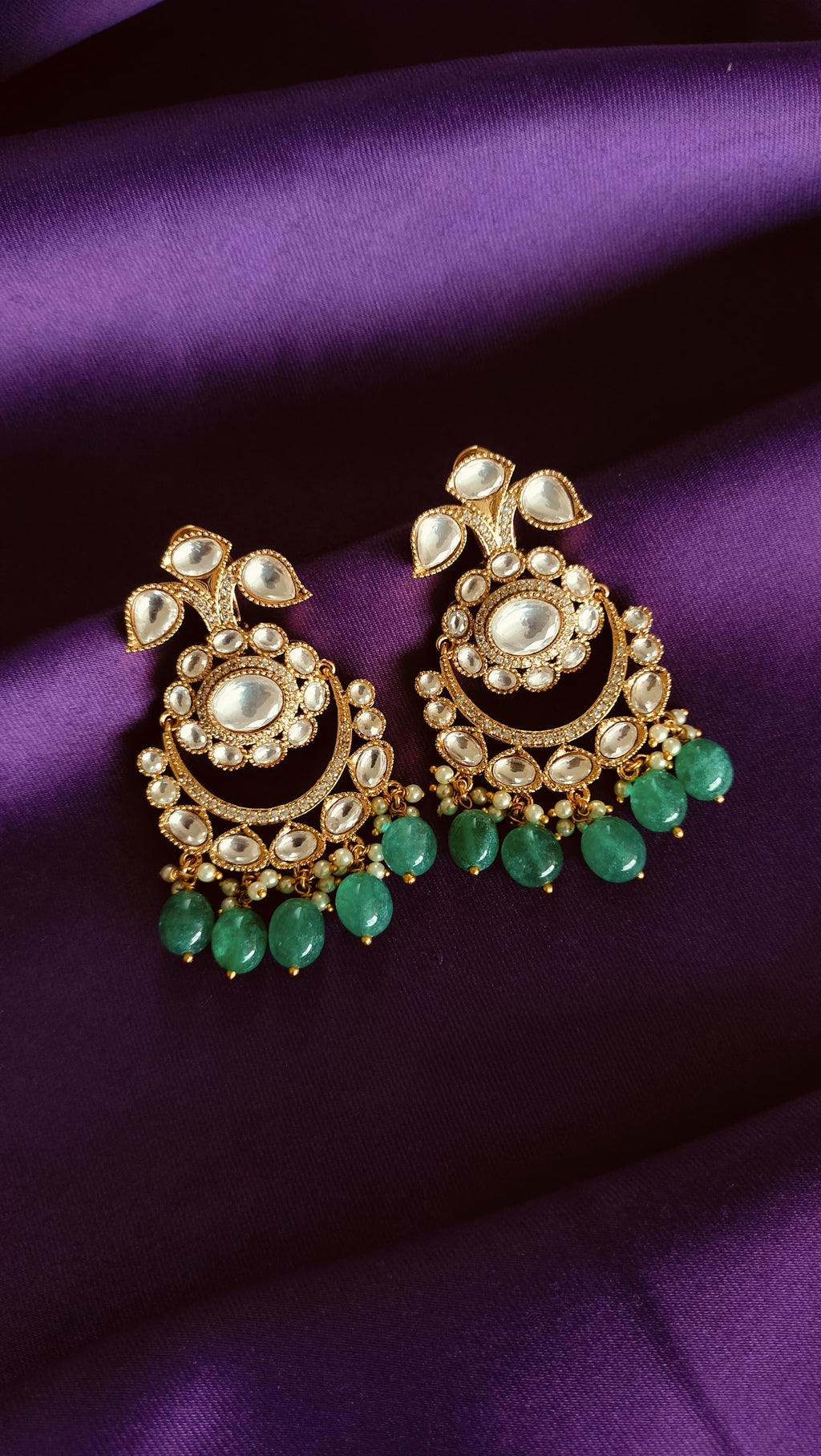 Gold Kundan Polki Chandbali Earrings pair flat lay on purple fabric