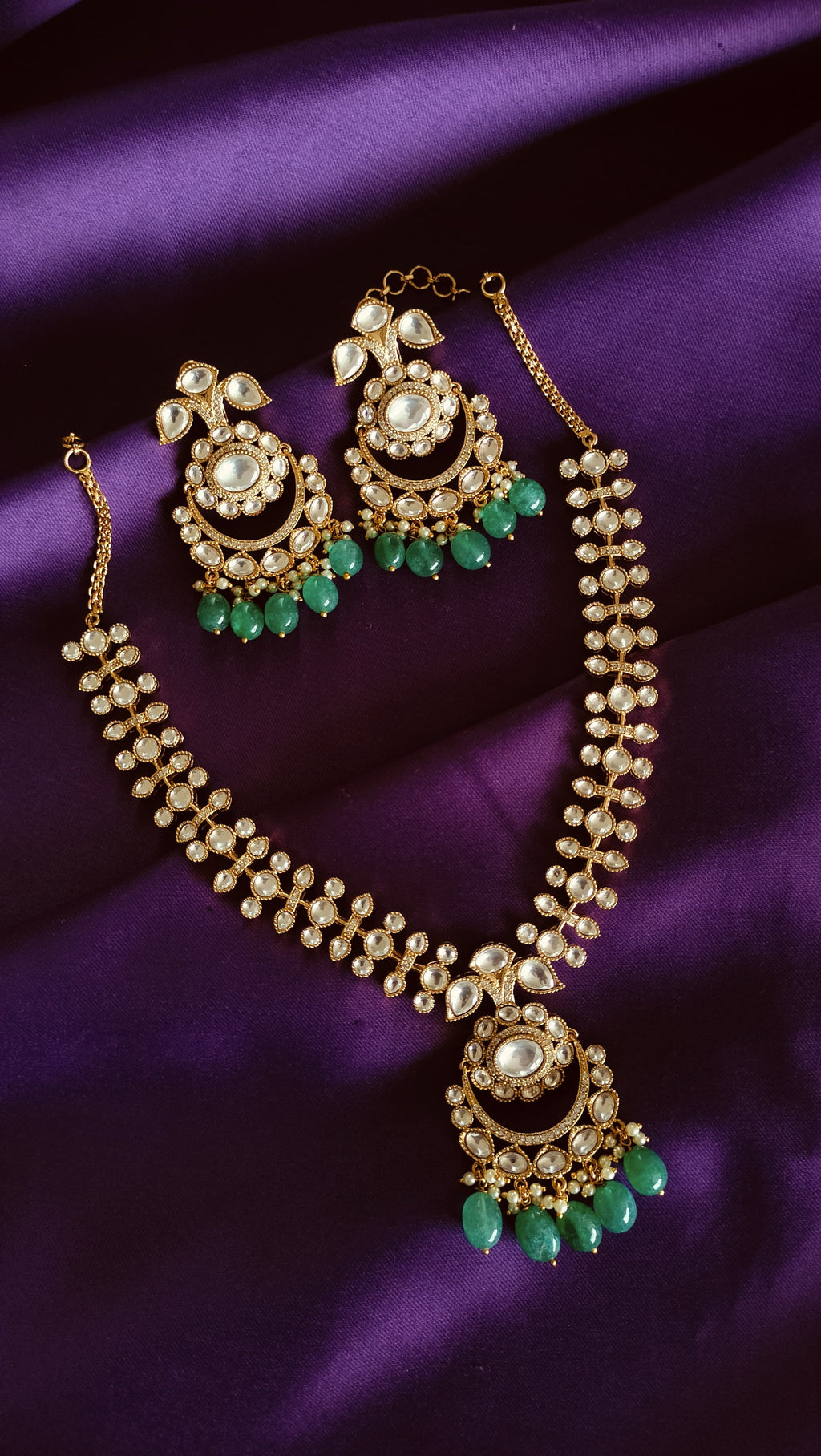 Gold Kundan Polki Chandbali Necklace & Earrings Set full flat lay on purple fabric