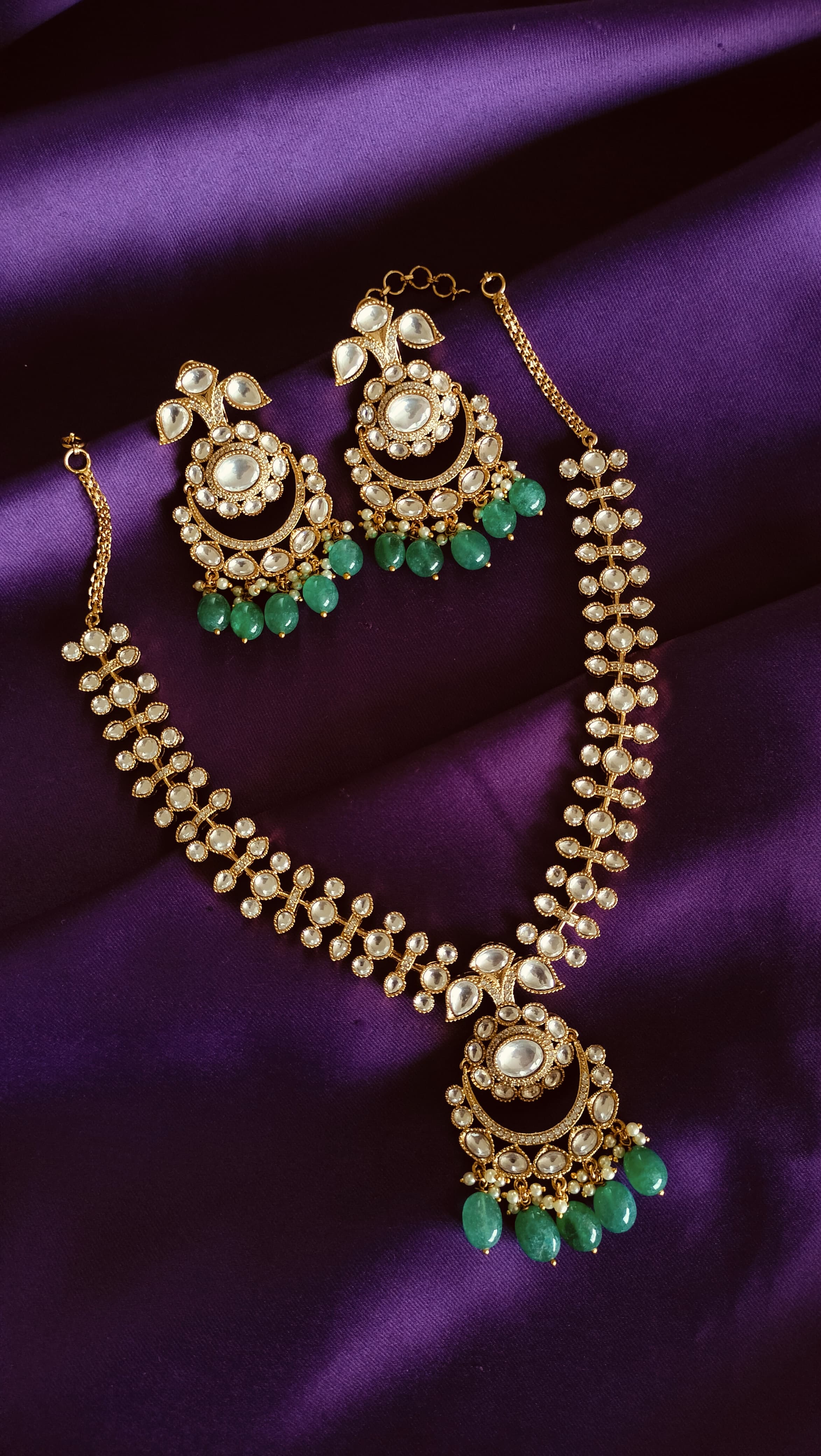 Gold Kundan Polki Chandbali Necklace & Earrings Set full flat lay on purple fabric