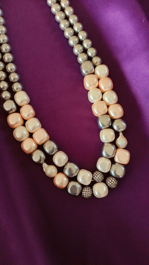 Double-Strand Graduated Grey & Blush Baroque Pearl Necklace centre detail close-up flat lay on purple fabric showing pavé ball stations and baroque pearls