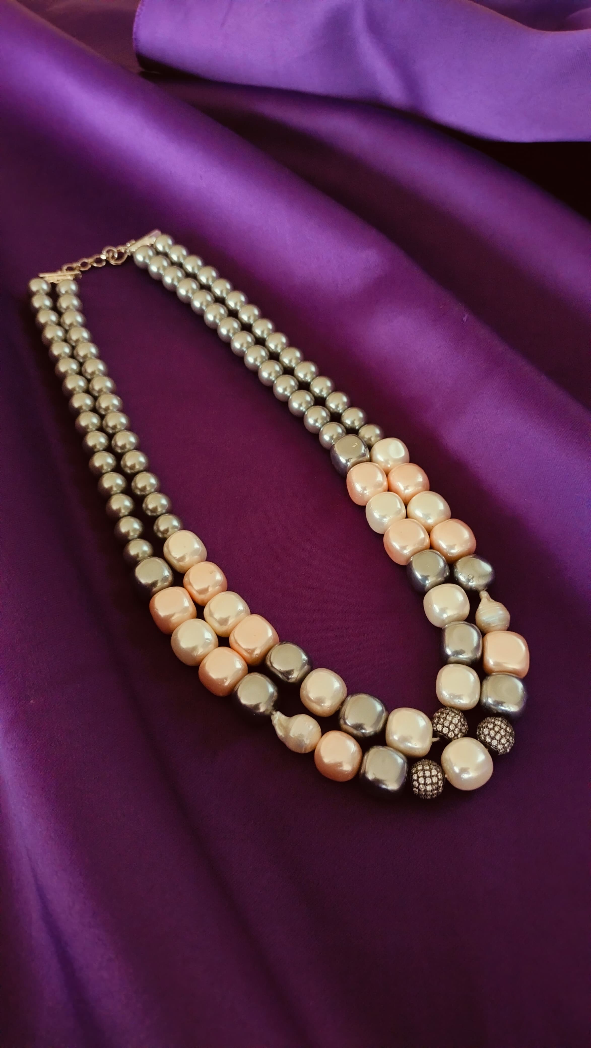 Double-Strand Graduated Grey & Blush Baroque Pearl Necklace full length flat lay on purple fabric showing toggle clasp and extender